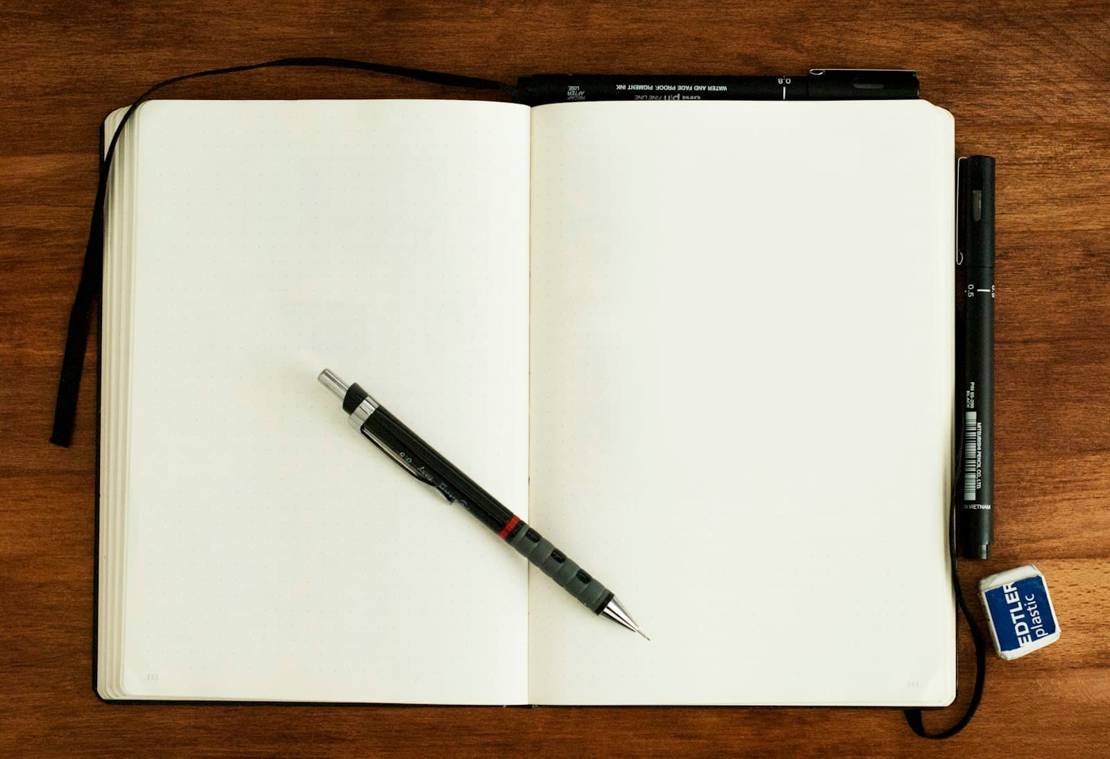 Open notebook with a pen, ready for a comparison list