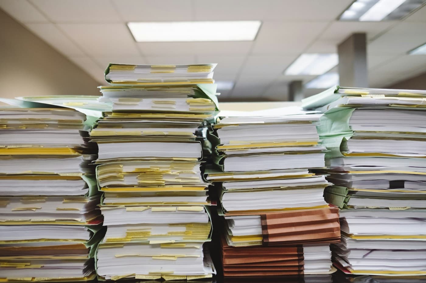 Stacks of paper files and documents in an office